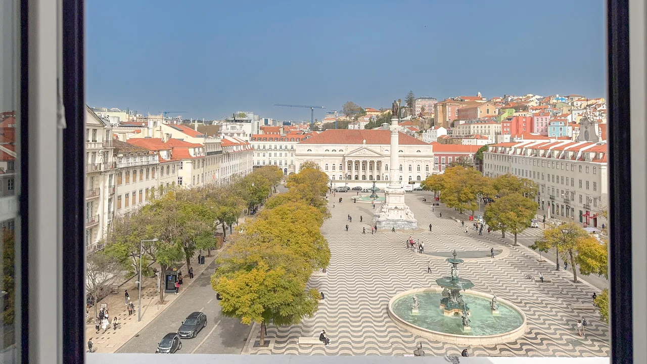 Rooftops of Lisbon's Baixa Pombalina with São Jorge Castle in the distance, seen from the apartment