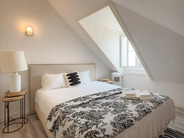 Main bedroom with a double bed under a skylight