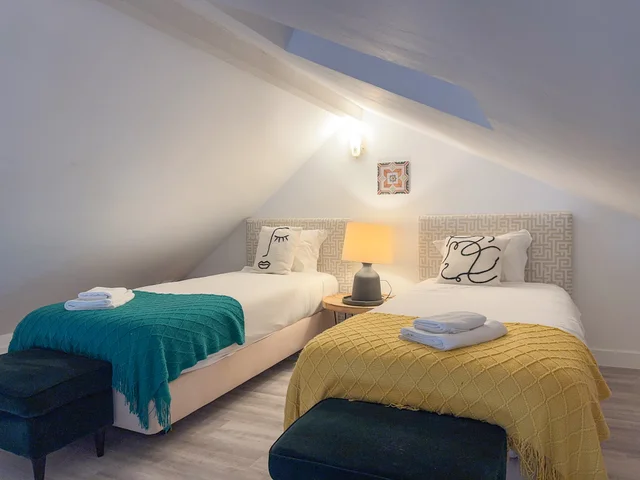 Second bedroom with two single beds and Picasso-print cushions