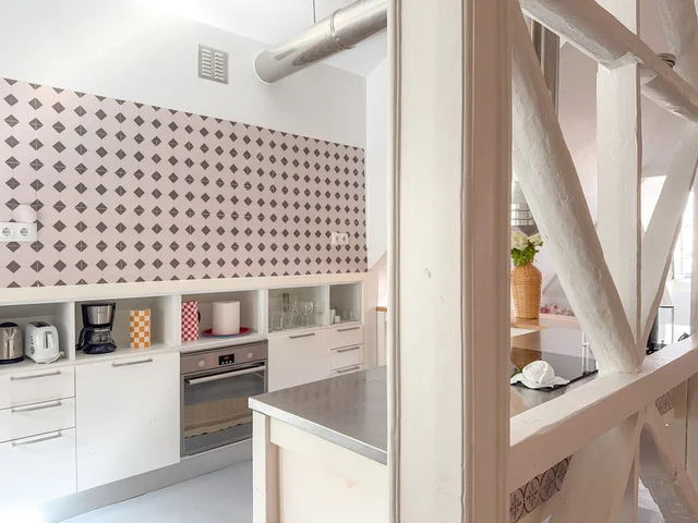 Fully equipped kitchen with diamond-pattern tile backsplash
