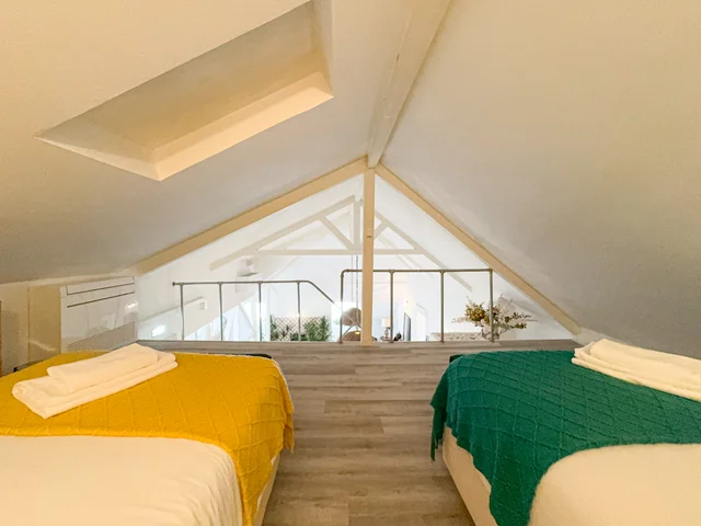 Mezzanine with two single beds under the roof beams