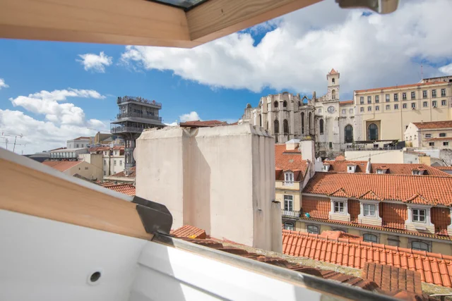 Lisbon rooftops with the Convento do Carmo ruins and the Santa Justa Lift, seen from the apartment skylight